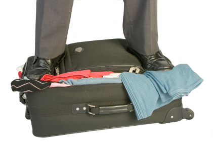 Businessman with Stuffed Suitcase